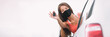 © Maridav - New car happy Asian driver woman wearing face mask for coronavirus showing keys with pride. Drivers license concept panoramic banner.