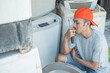 © Odua Images - electronics repairman having trouble repairing the washing machine at an electronics service