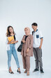 © Odua Images - Portrait of Happy College Friends carrying a bag and book on an isolated white