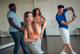 Group of people learning new movements during th dance class