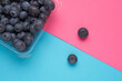 Creative layout made of blueberry on blue background. Flat lay. Food concept. Macro concept.