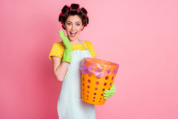 Sticker - Portrait of nice attractive cheerful cheery glad brown-haired maid holding in hands trash basket isolated over pink pastel color background