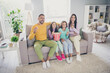 © deagreez - Photo of big full family four members sit sofa eat pop corn watch comedy series laugh wear colorful jumper trousers in living room indoors