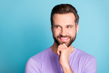 Sticker - Photo of young cheerful young man happy positive smile hand touch chin think look empty space isolated over blue color background