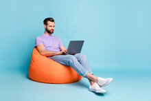 Full Length Body Size Photo Of Young Entrepreneur Working With Laptop In Beanbag Isolated On Bright Blue Color Background Empty Space