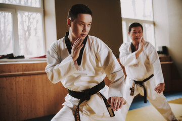 Wall Mural - A man in a kimono stands in a rack for an attack.