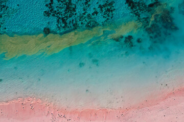 Top view of blue ocean with pink sandy beach at Flores island, Copy space
