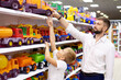 © Frame Fusion - Father and son purchase a toy car in a toy store.