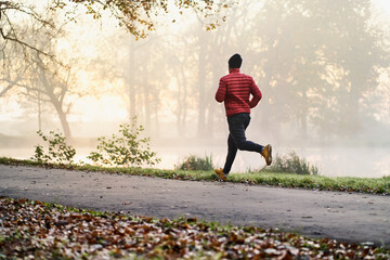 Wall Mural - Morning autumn run in the park - healthy lifestyle concept