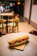 Sticker - Delicious sandwich on a wooden board served in a restaurant