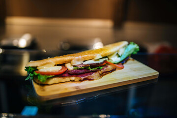 Sticker - Delicious sandwich on a wooden board served in a restaurant