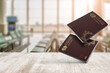 © hamzeh - Portuguese passport on a wooden balcony in the airport waiting room. Close-up view with selective focus , European Union ,floating in midair
