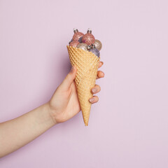 Wall Mural - Christmas waffle cone with Xmas balls on lilac background, Christmas and New Year holidays concept