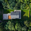 © Dariusz Jarzabek - Drone view of house in forest