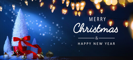 art christmas greeting card or banner background; christmas tree and holidays light on blue backgrou