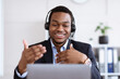 © Prostock-studio - Happy black businessman with headset having online conference