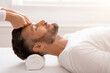 © Prostock-studio - Bearded man having relaxing head massage at spa