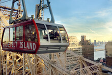 New York, USA - December 24, 2019: Cabin Of The Famous Roosevelt Island Cable Car In Front Of The Ed Coch Queensboro Bridge From Manhattan To Queens In New York.