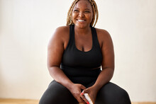 Plump, Plus Size African American Woman In Black Sportswear Posing In Studio, Concept Of Sport, Body Positive, Equality, People Diversity