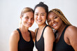 © Roman - natural beauty concept. three diverse females in black sportswear smiling at camera, african caucasian asian women with natural beauty