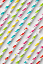 Top View Flat Lay Composition Of Multicolored Striped Plastic Straws For Drinks Arranged On White Background