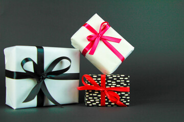 Wall Mural - Gifts wrapped with colorful paper on black background