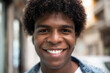 © David Espejo/ADDICTIVE STOCK - Positive African American male with Afro hairstyle and charismatic smile looking at camera while standing on blurred background of city