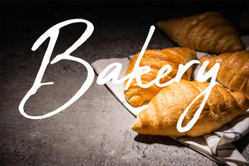 Wall Mural - fresh baked croissants on towel near bakery lettering on concrete grey surface