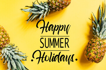 Wall Mural - top view of fresh tasty pineapples on yellow background with happy summer holidays illustration