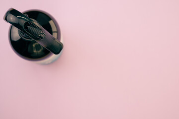 Canvas Print - High angle shot of a plastic spray bottle isolated on a pink background