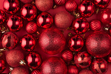Christmas Decorations Concept. Top Above Overhead View Close Up Photo Of Beautifully Decorated Red Baubles  Isolated On Red Background