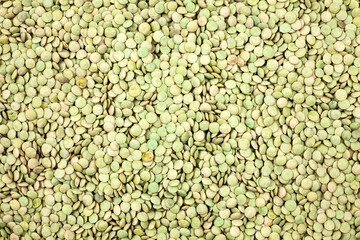 Heap of green raw lentils isolated on background