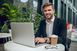 © zinkevych - Handsome young businessman working outside and smiling