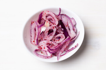 Sticker - Red onion with sumach, salt and lemon juice in white bowl