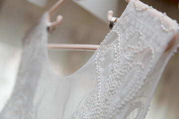 Sticker - Closeup shot of the bride's dress on a hanger