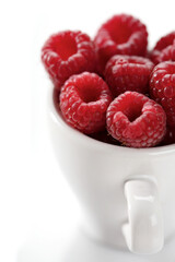 Wall Mural - Raspberries in white cup - close-up