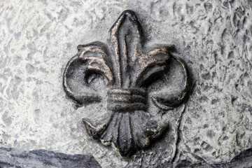 Fleur-de-lis on Antique plaster background.