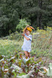 © Angelina - Cute, little girl with yellow flowers on her head eats a carrot