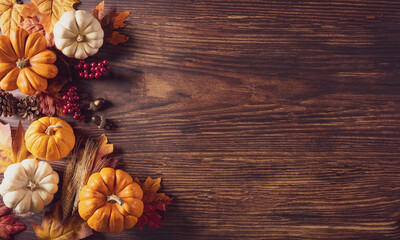 Wall Mural - thanksgiving background decoration from dry leaves and pumpkin on old wooden background. flat lay, t