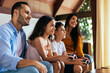 © kleberpicui - Latin family enjoying the day together at home playing video games on the couch