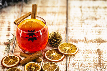 Wall Mural - Hot Christmas punch with citrus fruits on a winter table, front view, festive warming alcohol concept