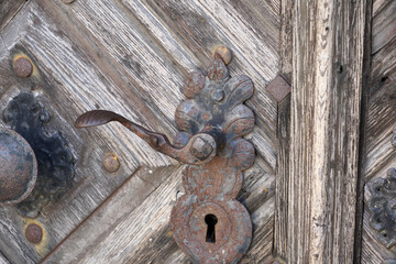 Sticker - Closeup shot of an old wooden door with an old handle