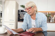 Woman does household bookkeeping and calculates monthly expenses
