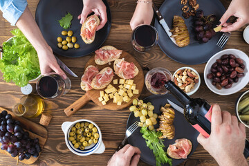 Canvas Print - Top view of group of people having dinner together. Dinner with friends concept