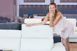 © JackF - Portrait of adult woman consumer choosing sofa in furniture shop