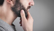 © andranik123 - Caucasian bearded man in grey background.