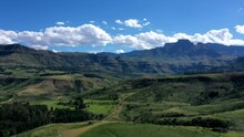 Time-lapse Of Lush Green Valley And Blue Mountains With Fast Moving Clouds Over Drakensberg Mountains, South Africa