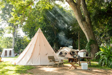 A Large White Traditional Teepee Tent With Luxurious Glamping Interiorwith Desk And Chairs In Forest,holiday/vacation,Camping