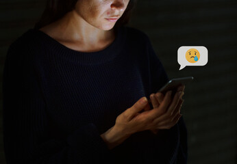 Woman using her mobile phone in the dark
