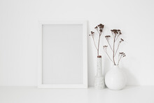 Mock Up White Frame And Vase On A Table.